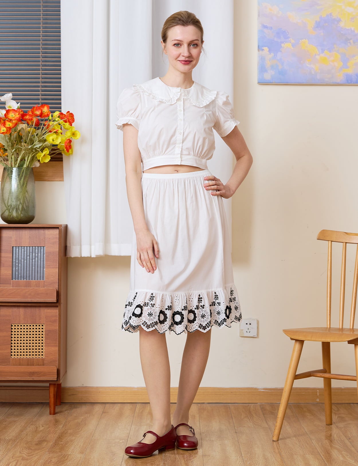 Tudor-Inspired Half Slip: full front view of cotton skirt extender with black floral hem styled in a retro room.