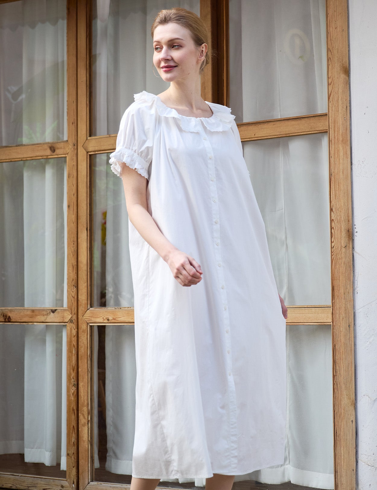 Model walking in a flowing white Sueasyretro vintage house dress.