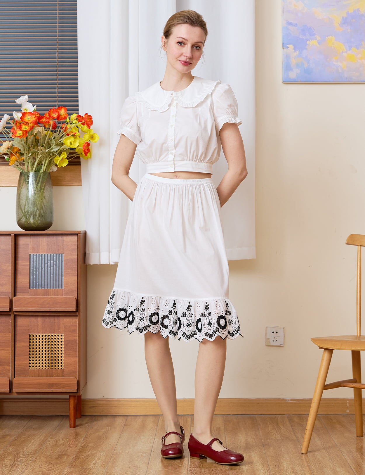 Vintage Petticoat: front view of pure cotton half slip with bold blackwork floral hem, hands behind back pose.