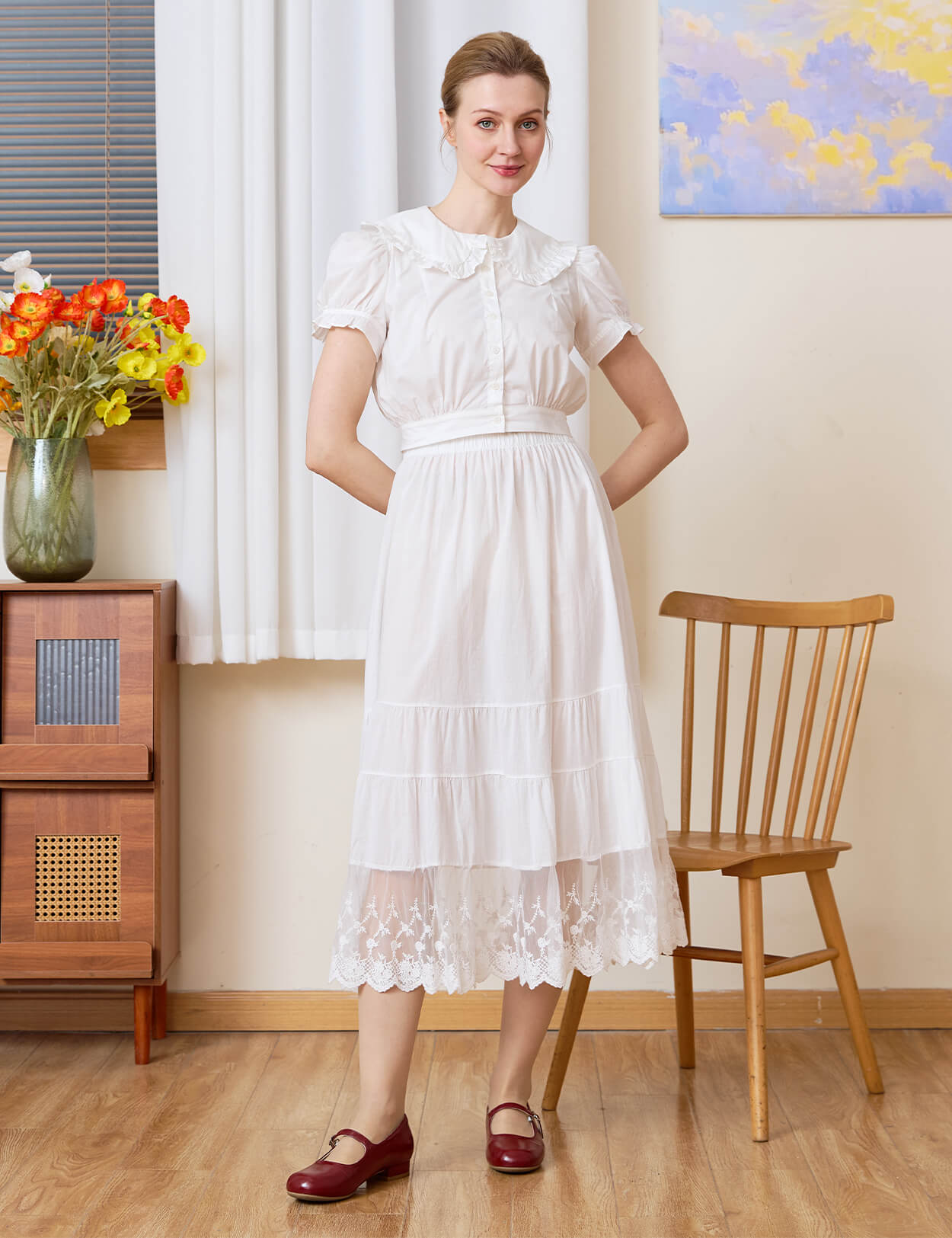 Model wearing the versatile Sueasyretro white cotton A-line skirt slip with tiered lace hem.