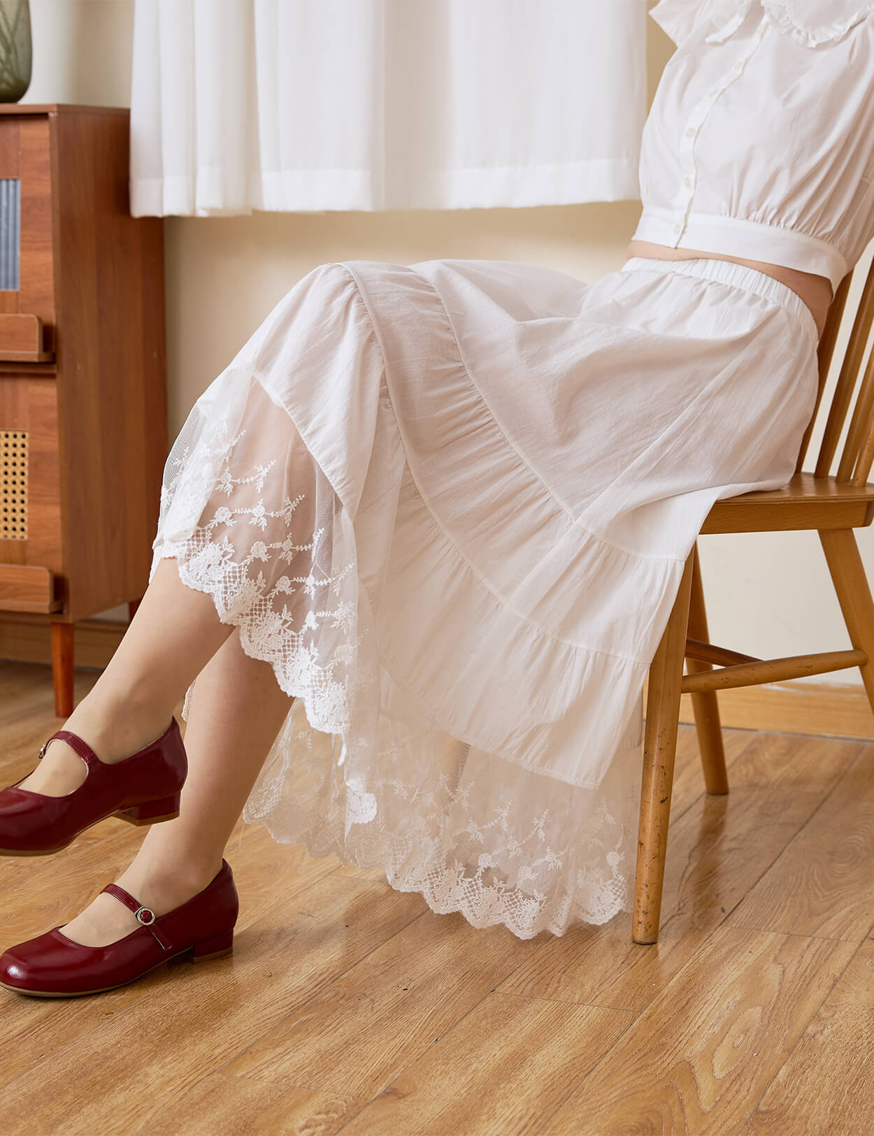 Close-up of the durable tiered lace hem on the Sueasyretro cotton skirt extender while sitting.