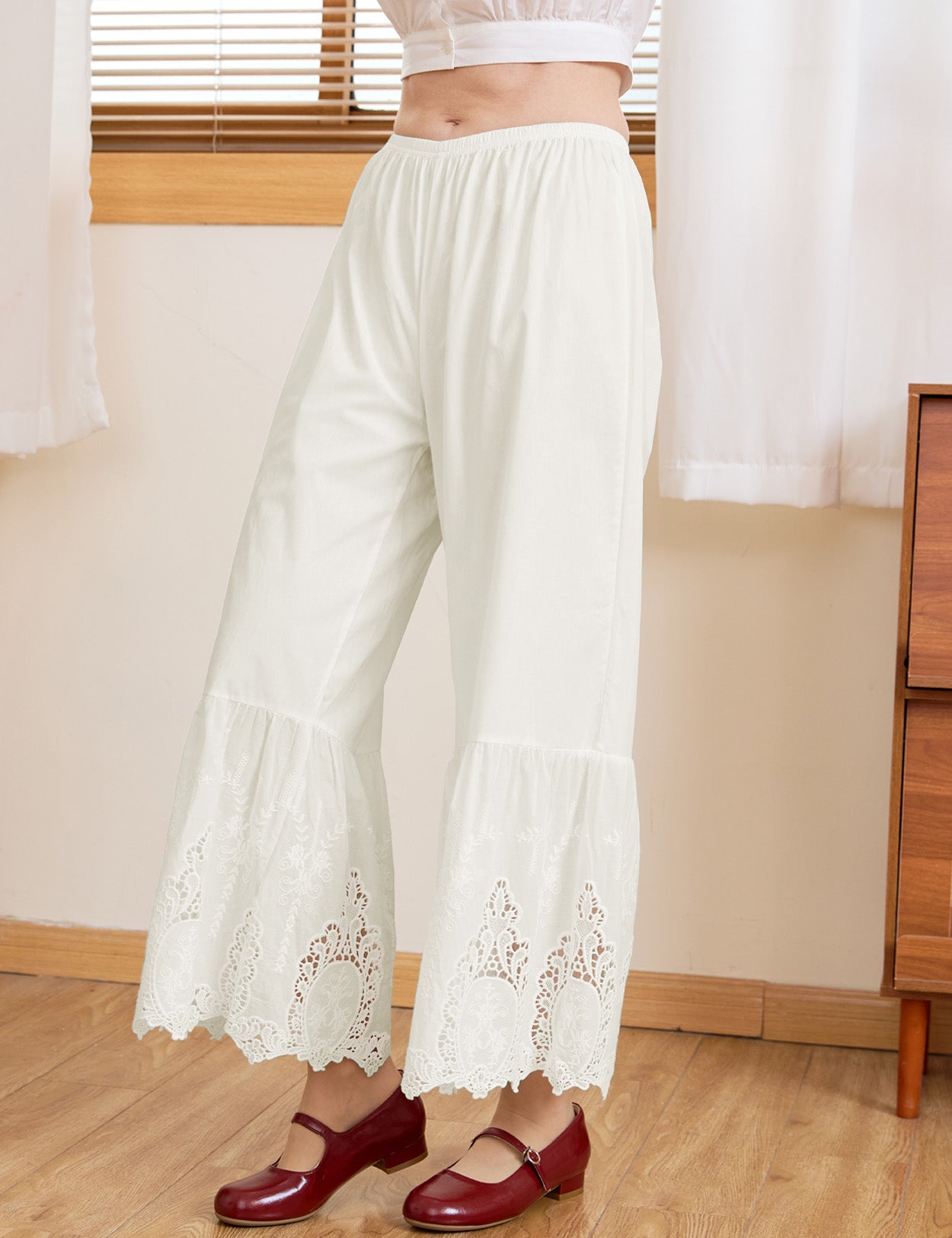 Detail of Victorian-inspired wide-leg lace hems on Sueasyretro cream 100% cotton bloomer pants.