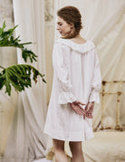 Back view of a white Victorian Renaissance dress, showing the extra-wide loose fit that is plus-size friendly.