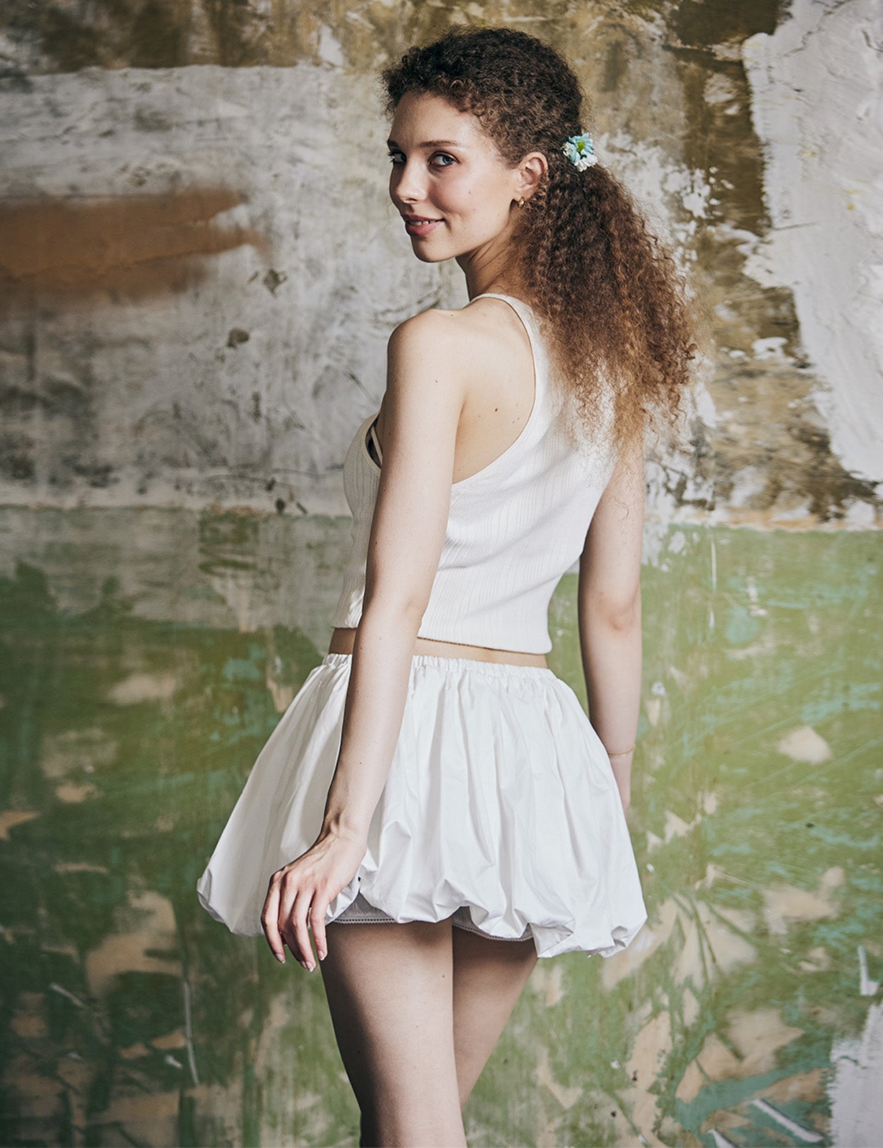 Back view of women's white cotton mini bubble skort with Y2K style pleating