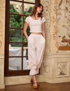 Sueasyretro cotton Pettipants worn as retro-inspired loungewear. White cotton bloomers with pockets and ruffles.