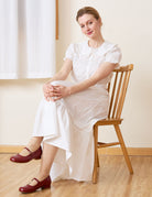 Sueasyretro white 100% cotton midi skirt with ruffle hem, sitting pose.