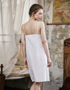 Women's white cotton full slip with spaghetti straps, showing comfortable fit and classic design - back view