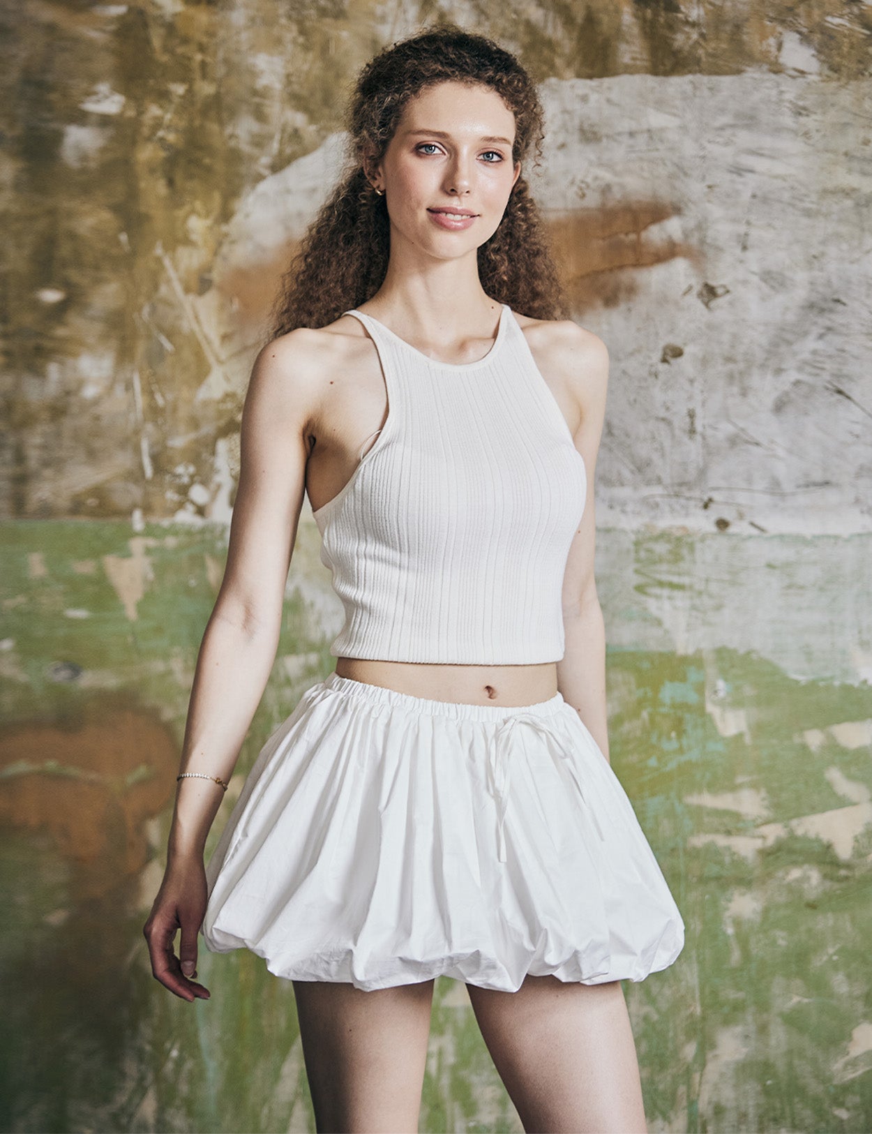 Front view of women's white cotton mini bubble skort with pleated design and Y2K styling